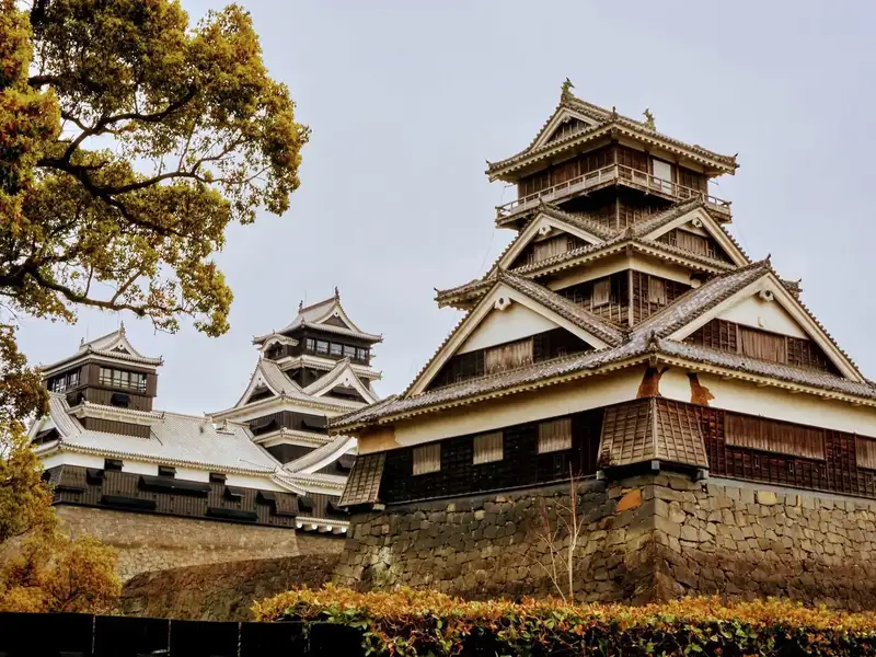 Kumamoto Castle flanked by yellow autumn leaves