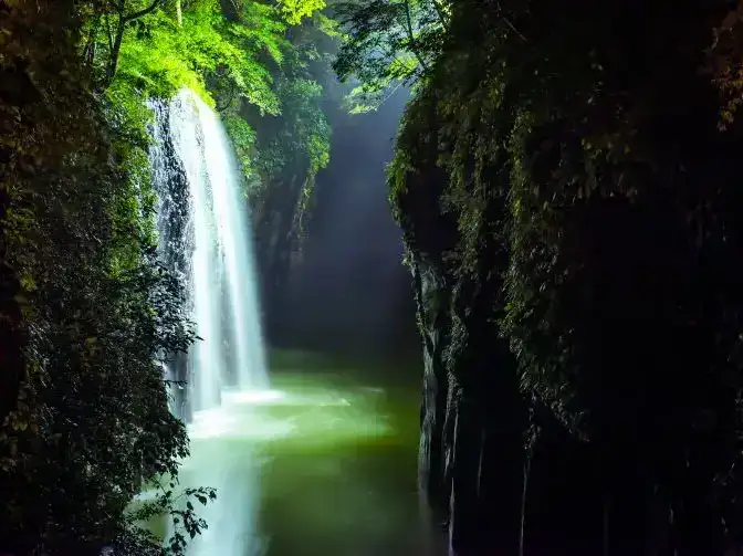 Waterfall rushing into a stream in Takachiho Gorge