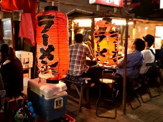 Paper lamp glowing beside yatai stall in Fukuoka city