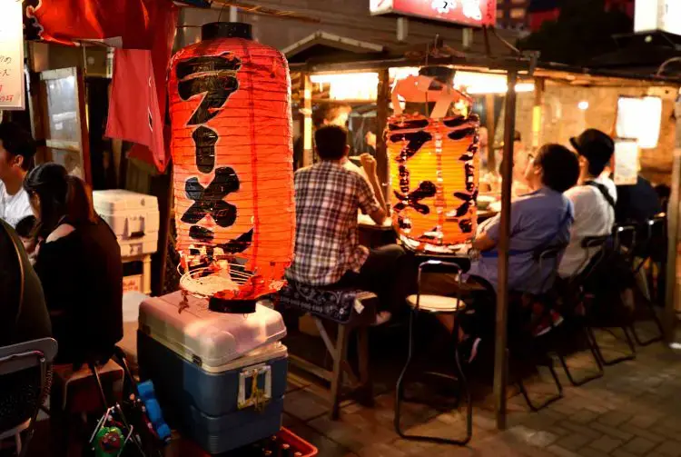 Paper lamp glowing beside yatai stall in Fukuoka city